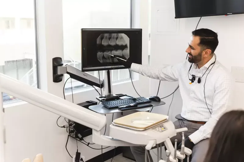 Dr. Moradian reviewing digital X-rays with a patient